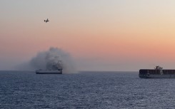 All 22 crew members were rescued by the crew of motor vessel Cosco Hellas with no reported injuries. US Coast Guard/Courtesy of Roland Hobson/AFP