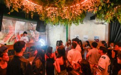 Attendees listening to music while drinking coffee at an alcohol-free clubbing event in Singapore. AFP/Roslan Rahman