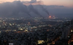 Smoke billows from a site in the city of Haifa following a fresh barrage of Iranian missiles. AFP/Ahmad Gharabli