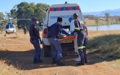 Forensic services carry a body of young boy into their car during rescue operations in Mthatha. - Eastern Cape floods