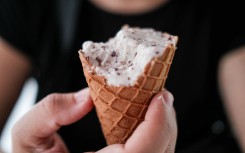 A hand holding a half-melted ice cream. Romain Costaseca/Hans Lucas via AFP