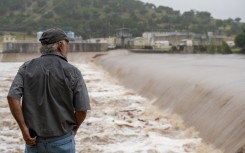 A Kerrville resident watches the rising waters of the Guadalupe River. Eric Vryn/Getty Images/AFP