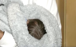 Baby Mogamat fast asleep in his mother's arms.