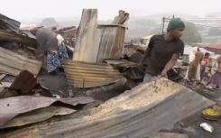 Kennedy Road residents picking through the destroyed structures.