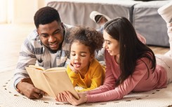 image of family reading a book together. 