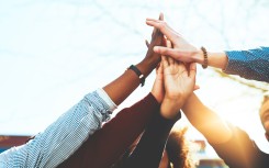 a high five with a diverse a group of people 