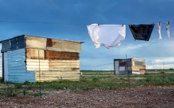 File: A school uniform hangs among shacks. GettyImages/Per-Anders Pettersson