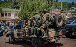 File: M23 rebel soldiers board pickup trucks in Goma. AFP/Jospin Mwisha