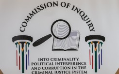 A general view of a logo of the Commission of Inquiry into criminality, political interference and corruption in the criminal justice system. AFP/Phill Magakoe