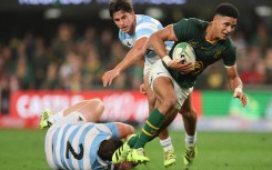 South Africa's fly-half Sacha Feinberg-Mngomezulu (R) runs with the ball to score a try during the Rugby Championship Test match between South Africa and Argentina at Kings Park Stadium in Durban on September 27, 2025.