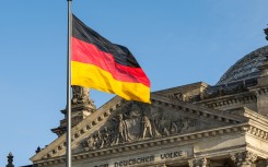 The German flag fluttering in front of Reichstag building. GettyImages/arsenisspyros