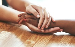 hands held together across a table