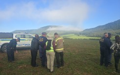 Search teams on the ground near the plane crash. Supplied