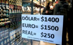A sign with exchange rates is pictured on a gift shop in Buenos Aires. AFP/Juan Mabromata