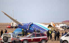Emergency specialists work at the crash site of an Azerbaijan Airlines passenger jet near the western Kazakh city of Aktau on December 25, 2024.