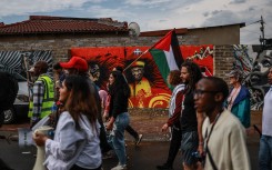 Protesters from South African Christians for Palestine and the Muslim community hold pro-Palestinian posters and flags during their march in Soweto 