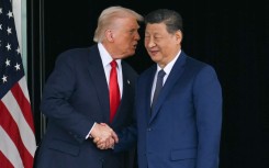 US President Donald Trump (L) and China's President Xi Jinping shake hands as they leave after their talks at the Gimhae Air Base. Photo by Andrew Caballero-Reynolds/ AFP 