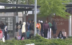 The stranded students sitting outside the gate.