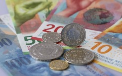 Swiss franc banknotes and coins. Robert Schmiegelt/Geisler-Fotopr/dpa via AFP