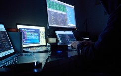 File: Pages and hacker programs are seen on screens. Annette Riedl/dpa via AFP 