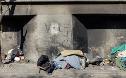 File: A homeless man sleeping under an underpass. AFP/Gianluigi Guercia