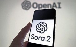 File: A Sora2 logo on a smartphone with the OpenAI logo. Guo Dexin/CFOTO via AFP