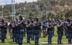 Members of the South African Police Service (SAPS) stand at attention during the Integrated Law Enforcement parade near the Nasrec Expo Centre in Johannesburg, on November 19, 2025.
