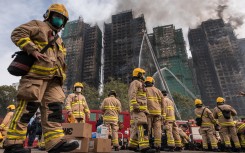 Hong Kong firefighters scouring the apartment complex after the blaze tore through the high-rises. AFP/Dale De La Rey