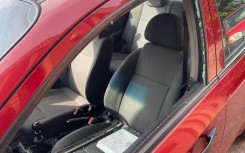 A red Chevrolet Aveo sedan, with a shattered window belonging to Brown Mogotsi