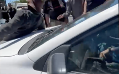 The victim on the hood of the car.