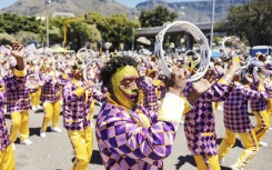 A Kaapse Klopse minstrel dances as his troupe moves forward during the annual Kaapse Klopse parade. AFP/Gianluigi Guercia