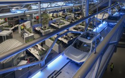 File: Body shells drive through the BMW Group plant in Leipzig. Jan Woitas/dpa via AFP