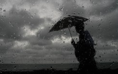File: A man with an umbrella walking in the rain. Thilina Kaluthotage/NurPhoto via AFP