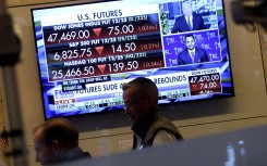 A television displaying market statistics is displayed as traders work on the floor of the NYSE. AFP/Timothy A Clary