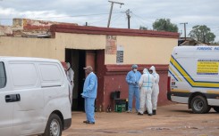 Forensic Pathology Services members stand at the scene of an attack at a tavern in Bekkersdal. AFP/Emmanuel Croset