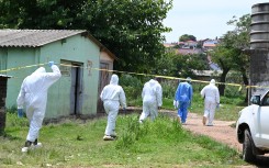 SAPS forensic teams examine a crime scene at Saulsville Hostel. Gallo Images/Frennie Shivambu