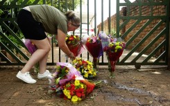 mbers of the public lay flowers in front of the gate after the murder of Marius van der Merwe. Gallo Images/Rapport/Elizabeth Sejake