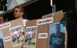 Community members protesting outside court.