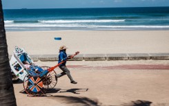 File: A rickshaw puller goes about his business with tourists on a ride at the North Beach. AFP/Rajesh Jantilal