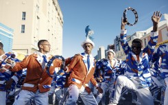 File: Kaapse Klopse minstrels dance as their troupe moves forward during the annual Kaapse Klopse parade. AFP/Gianluigi Guercia