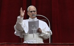 Pope Leo XIV addresses the crowd from the central balcony of St Peter's Basilica. AFP/Filippo Monteforte