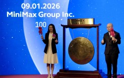 Shanghai-based AI startup MiniMax's CEO Yan Junjie (R) and Co-founder and COO Yun Yeyi (L) attend the firm's listing ceremony at the Hong Kong stock exchange. AFP/Tommy Wang