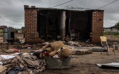A teddy bear in a tub in front of a damaged house following floods in Mbaula village, 50 km from Giyani. AFP/Paul Botes 