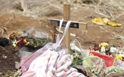 Flowers and candles at a memorial prayer at the scene of the accident that claimed the lives of 14 learners. Gallo Images/Sharon Seretlo