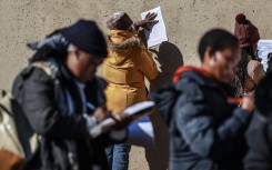 Unemployed people fill in the Department of Unemployment and Labour work seeking registration forms. AFP/Phill Magakoe
