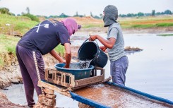 Residents wash soil in search of alleged gold deposits on makeshift tables at Gugulethu Informal Settlement in Springs. Gallo Images/OJ Koloti
