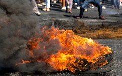 File: Protesters burning rubber tyres in the streets. GettyImages/FourOaks