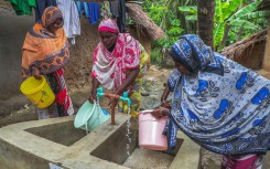 Women with buckets getting tap water. Emmanuel Herman/Xinhua via AFP