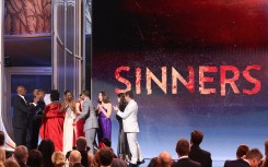 The cast of "Sinners" arrive onstage to accept the award for Outstanding Performance by a Cast in a Motion Picture. AFP/Valerie Macon