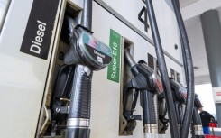 File: Fuel nozzles hang in the holder at a filling station. Peter Kneffel/dpa via AFP